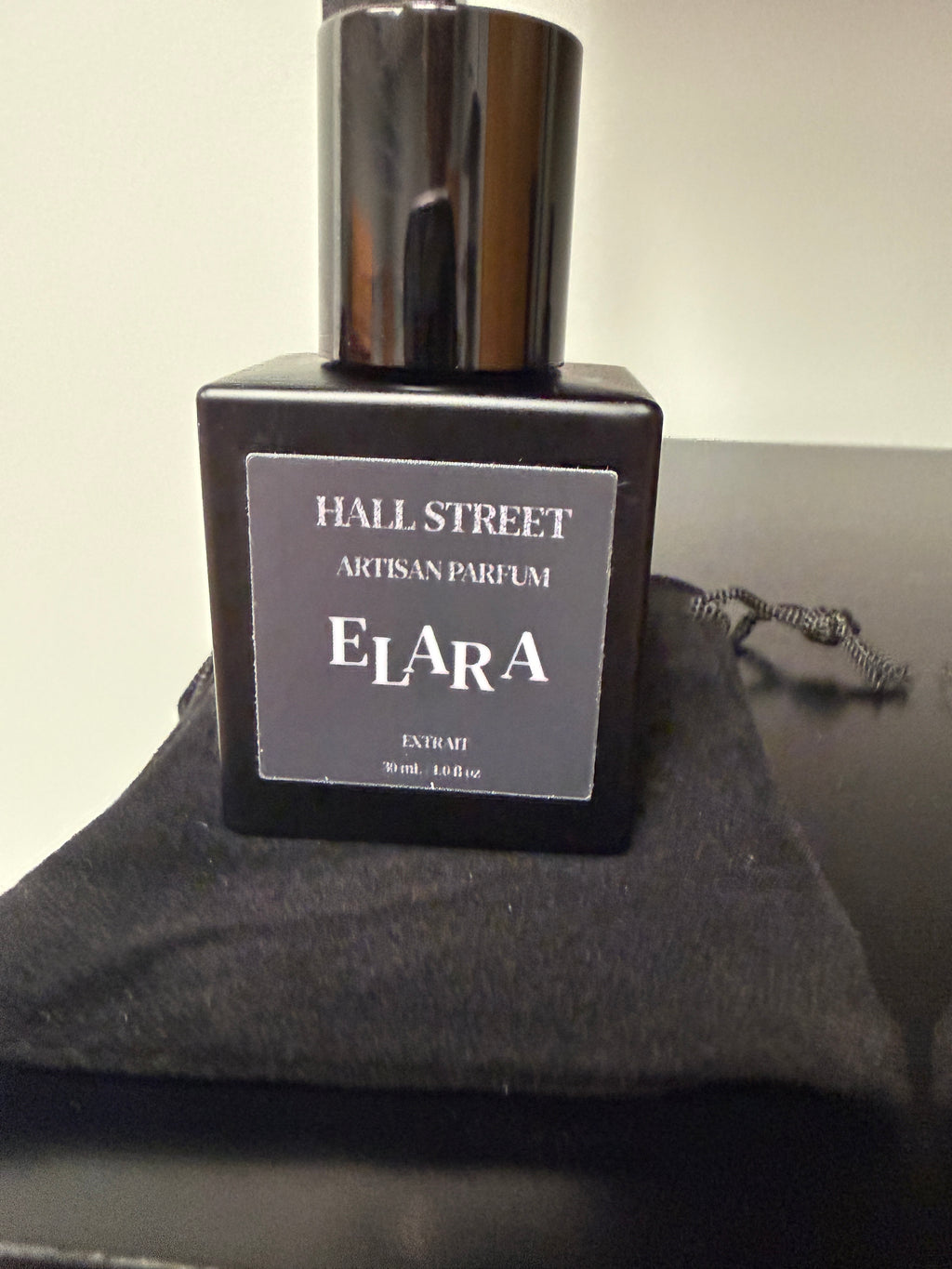 Perfume bottle labeled  Elara by Hall Street Artisan Parfum on a dark background.